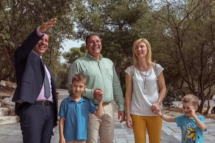Tour guide greeting family travelers on an Eger wine tasting day trip from Budapest, scenic countryside stop
