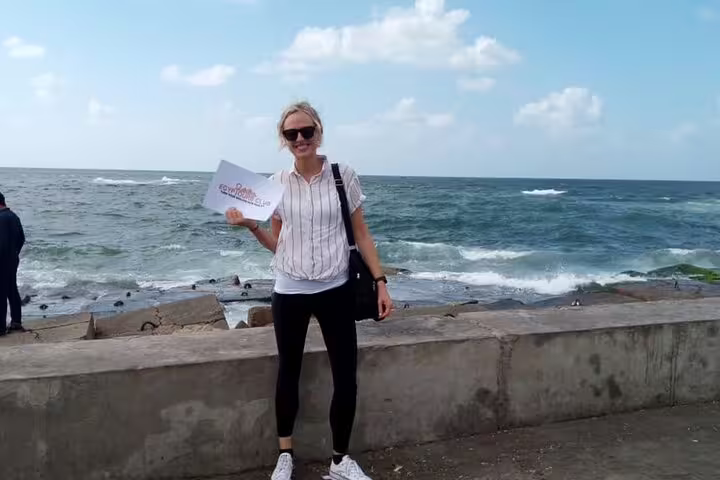 Traveler on Alexandria Corniche by the Mediterranean Sea, part of a 6-day Egypt tours package