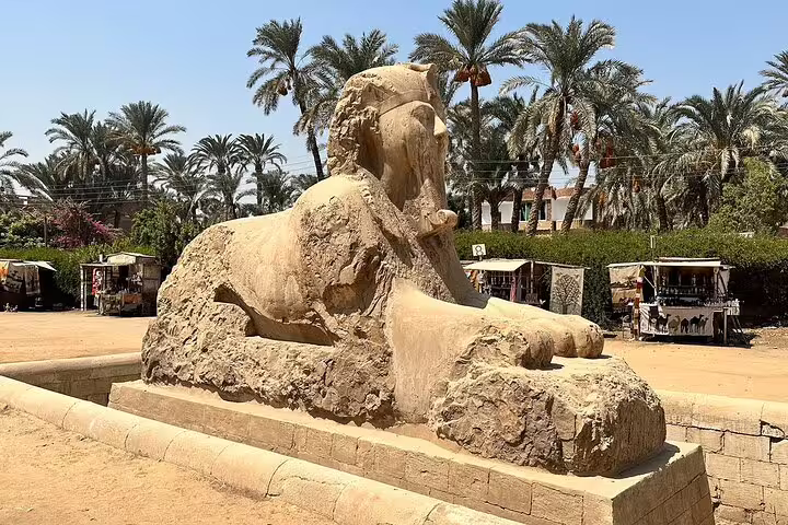 Ancient sphinx statue in Luxor surrounded by palm trees, featured in a 6-day Egypt tours package