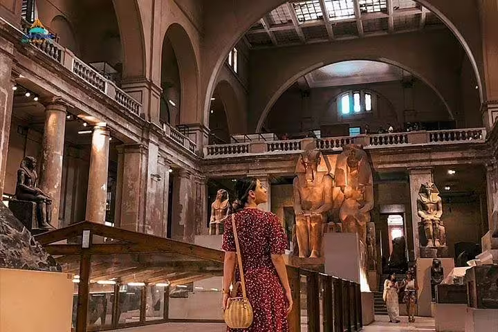 Inside Egyptian Museum Cairo hall with ancient statues, part of 2-day Alexandria to Giza and Cairo tour