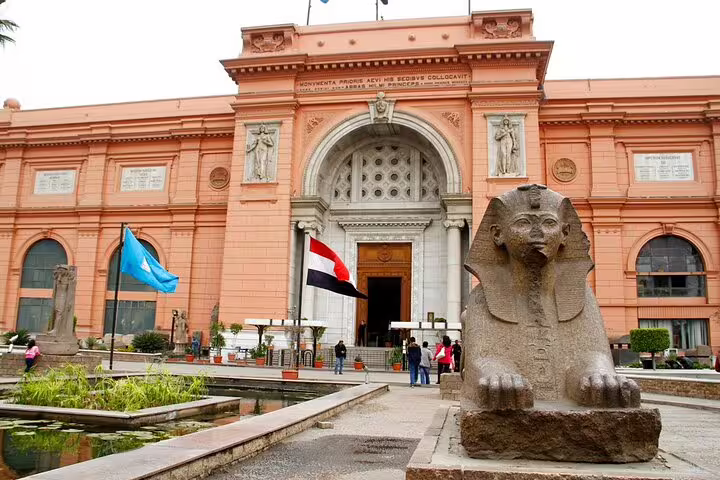 Egyptian Museum Cairo facade with sphinx statue and flags, stop on Egyptian Museum private guided tour