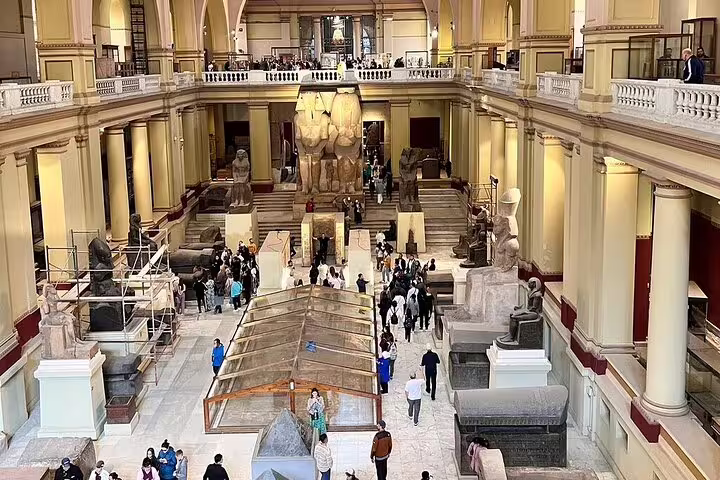 Grand hall of the Egyptian Museum in Cairo with statues and visitors, part of Hurghada to Pyramids of Giza day trip
