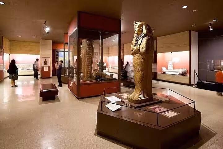 Inside Egyptian Museum Cairo gallery with pharaonic statue on Hurghada to Cairo day trip with lunch
