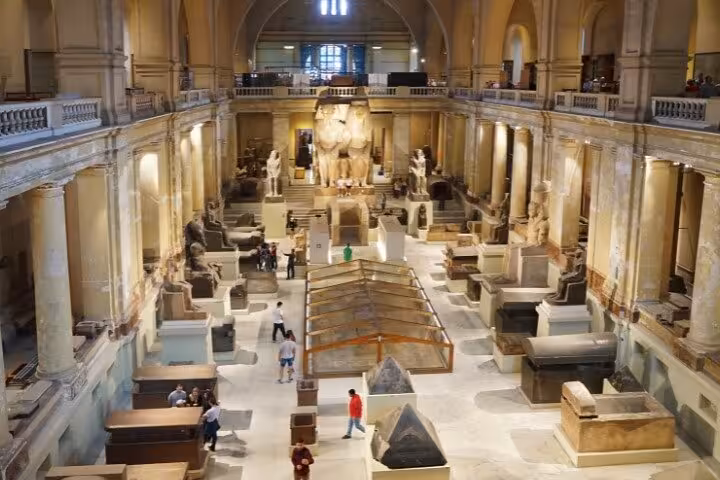 Egyptian Museum Cairo main hall with statues and sarcophagi, key stop on Cairo pyramids and museum tour