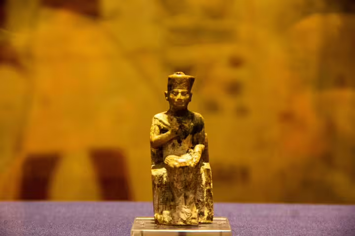 Ancient Egyptian seated statuette display inside the Egyptian Museum Cairo on a 4-hour private guided tour