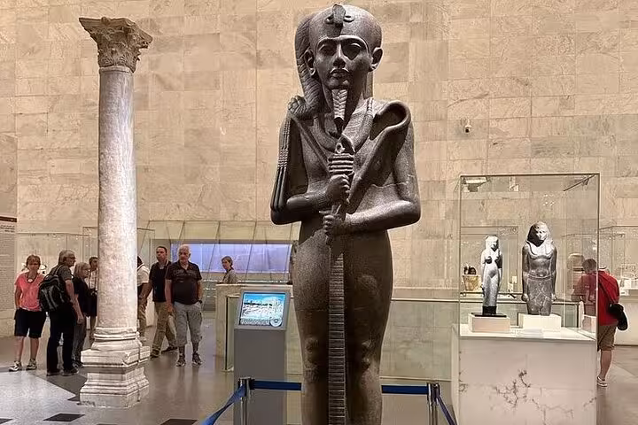 Ancient Egyptian pharaoh statue inside NMEC Cairo, featured on the Museum Citadel and Khan El Khalili tour