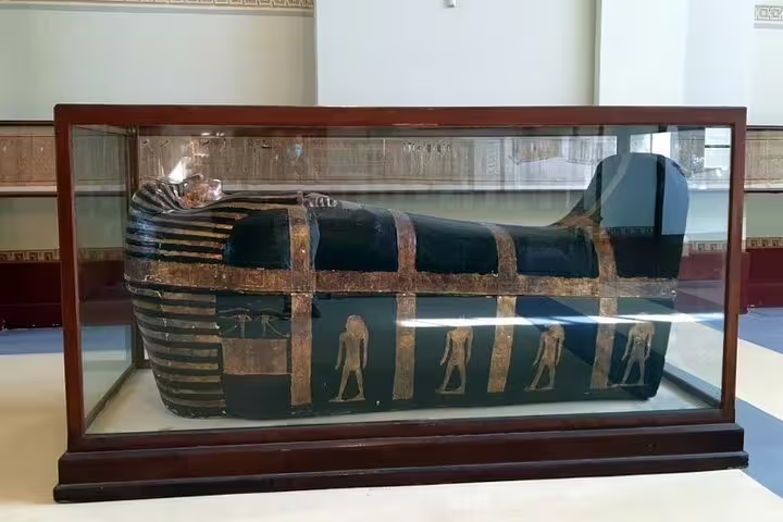 Ancient Egyptian sarcophagus in a glass case at Cairo Egyptian Museum on Pyramids of Giza day trip