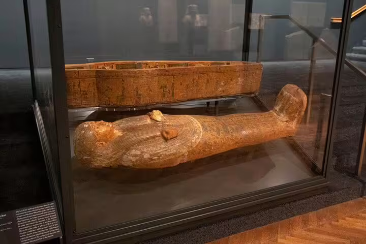 Ancient Egyptian wooden sarcophagus display at Cairo Museum on Pyramids of Giza tour from Hurghada