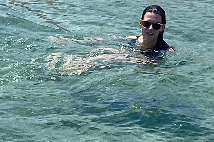 Traveler swimming in clear Red Sea water on El Ain El Sokhna day tour from Cairo, Egypt beach escape
