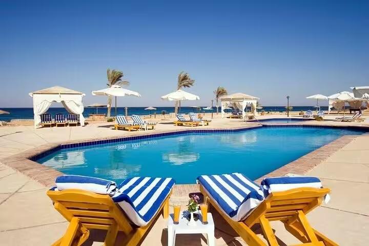 Resort pool with sunbeds and sea view on El Ain El Sokhna day tour from Cairo, Red Sea getaway