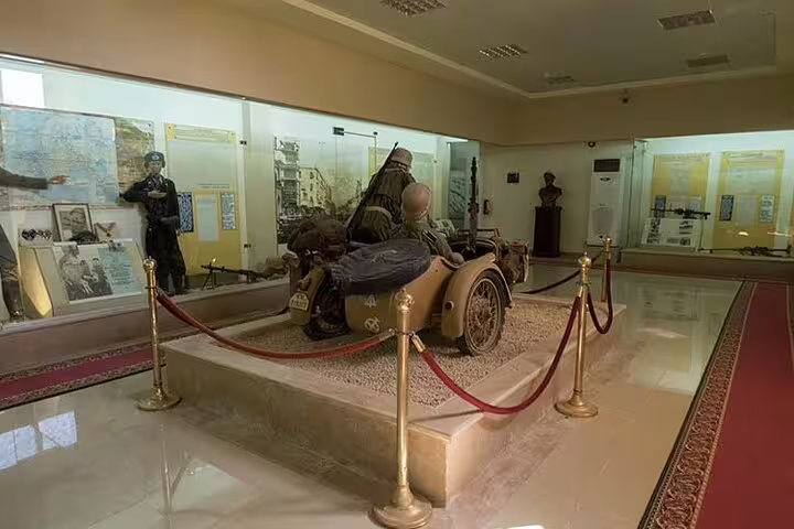 El Alamein Military Museum exhibits with WWII sidecar and artifacts, highlight of El-Alamein day trip from Cairo