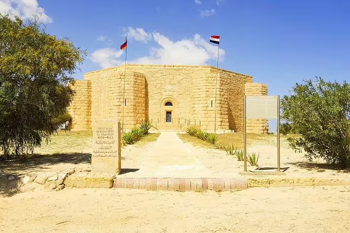 El Alamein war memorial cemetery building with flags, visited on private tour from Cairo to Alexandria