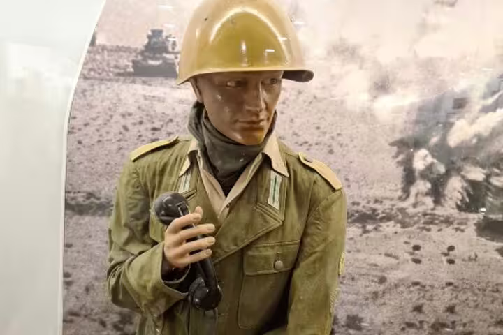 WWII military mannequin with helmet and field phone at El Alamein War Museum on Cairo day tour