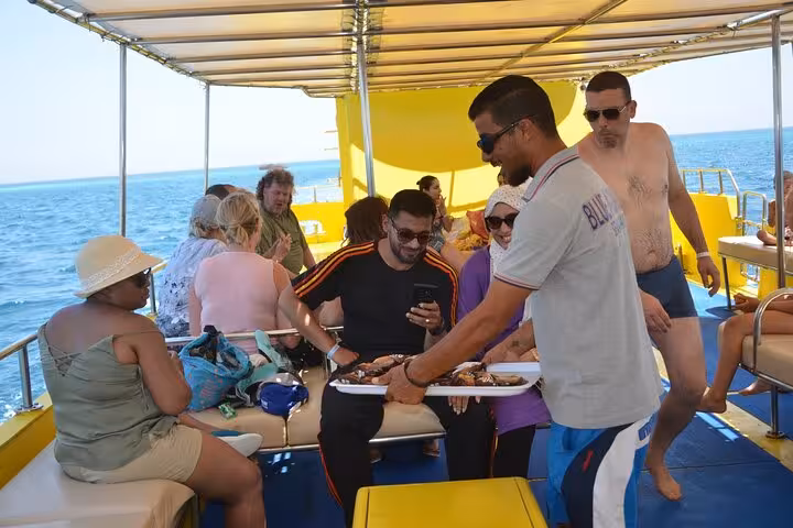 Guests relax on deck during El Gouna semi submarine cruise, enjoying Red Sea views after departure from Abu Tig Marina