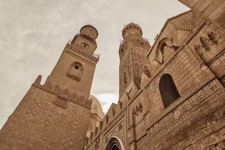 Historic mosque minarets on El-Muizz Street in Islamic Cairo, featured on dinner and Cairo Tower tour