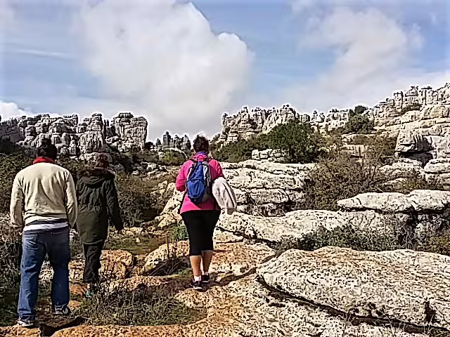 Small group hiking El Torcal de Antequera karst trail on a private trip with hotel pick-up from Malaga area