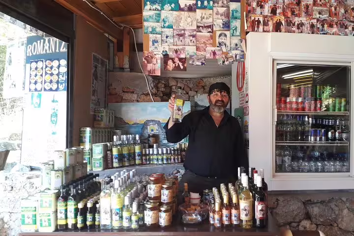 Local vendor showcasing traditional products in a rustic shop, part of Elafonisi Beach private tour from Chania, Crete.