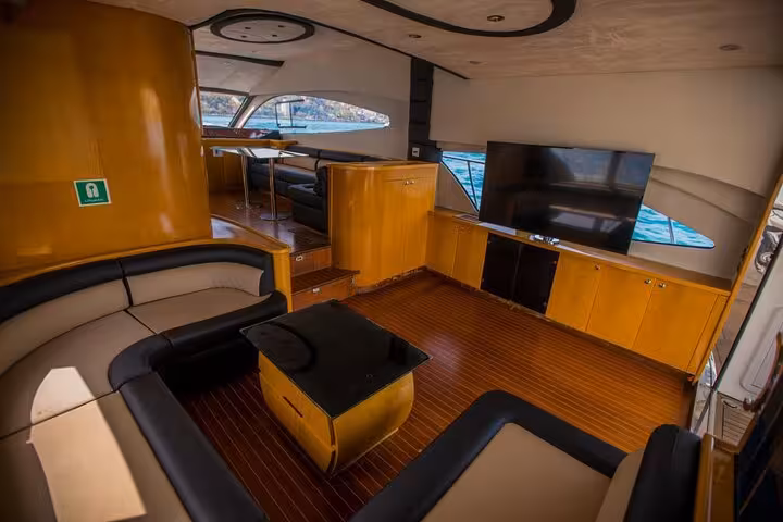 Elegant yacht salon lounge with TV and seating, perfect for private birthday or anniversary celebration cruise