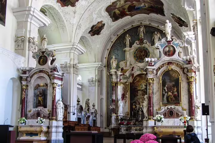 Exquisite baroque interior of Engelberg Abbey with ornate altars and stunning frescoes, perfect for cultural exploration.