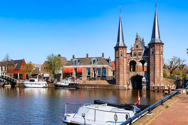 Enkhuizen harbor with historic gate towers and canal boats on Northern Highlights day trip from Amsterdam
