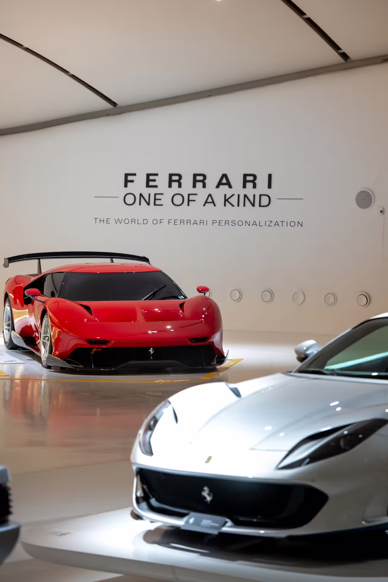 Supercars on display at Enzo Ferrari Museum Modena, “Ferrari One of a Kind” hall with red and silver models