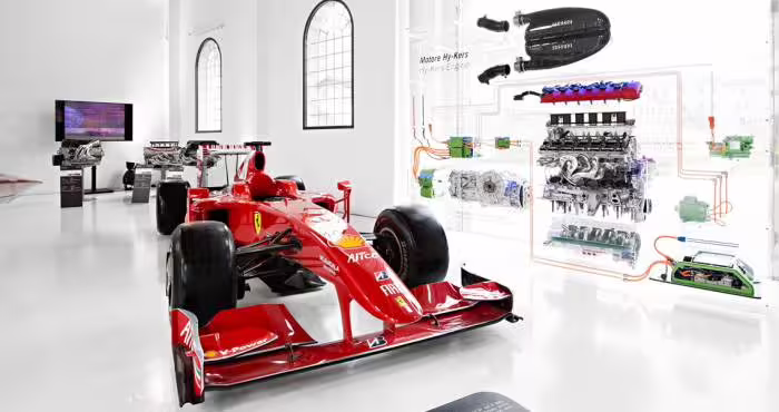 Red Ferrari Formula 1 race car display inside Enzo Ferrari Museum Modena, included with entrance ticket
