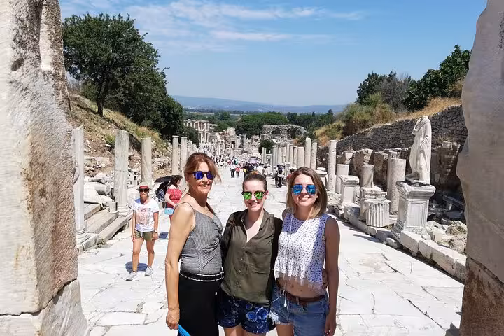 Cruise shore excursion at Ancient Ephesus, tourists on Curetes Street ruins near Kusadasi port, Turkey