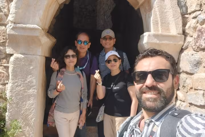 Travelers selfie at an ancient stone archway on Ephesus cruise port tour, guided visit with lunch included