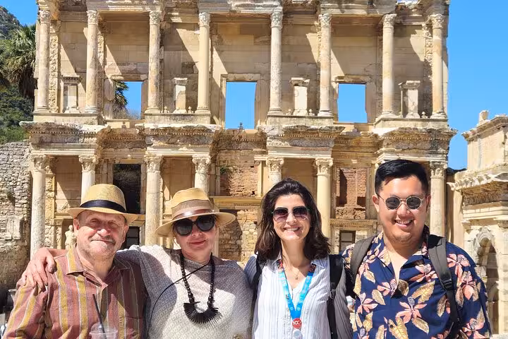 Travelers at Ephesus Library of Celsus facade on guided Ephesus tour from Izmir hotels, sunny day visit