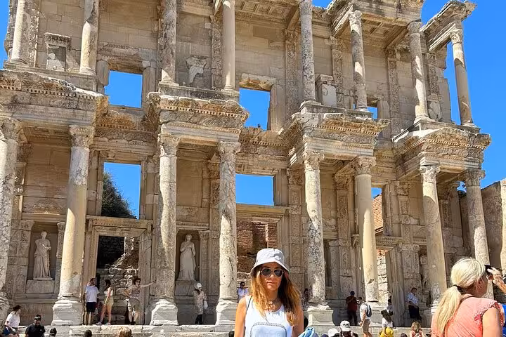 Traveler posing at the Library of Celsus in Ephesus on a full-day Ephesus and House of Mary tour from Bodrum
