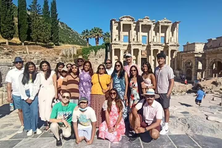 Group of tourists posing in front of the ancient Library of Celsus during an Ephesus private shore excursion from Kusadasi.