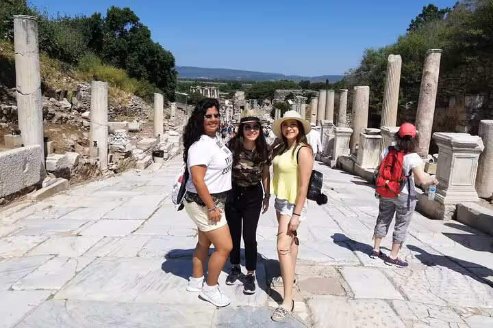 Visitors posing on Ephesus Marble Street with columns on a private skip-the-line tour for cruise passengers