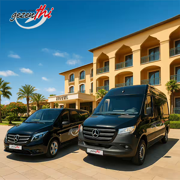 Two black Mercedes vans parked outside a hotel entrance, prepared for tourist transportation.