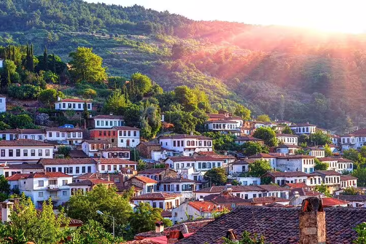 Charming hillside village near Ephesus bathed in sunset, featured in the Ephesus & Wine Tasting Tour from Kusadasi Port.