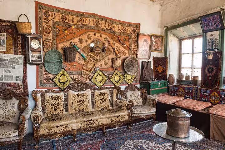 Vintage Erzurum Ottoman-style sitting room with rugs, carved sofa and antiques on a private guided city tour