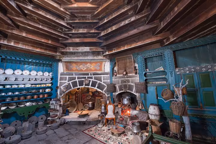Traditional Erzurum house museum kitchen with copperware, hearth and shelves on a private guided city tour