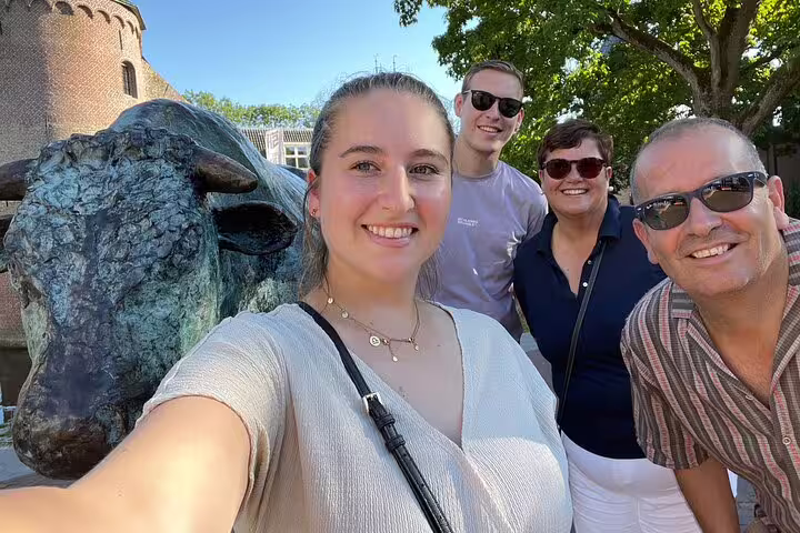 Friends selfie by Nancy bull statue during e-Scavenger Hunt, exploring city landmarks at your own pace