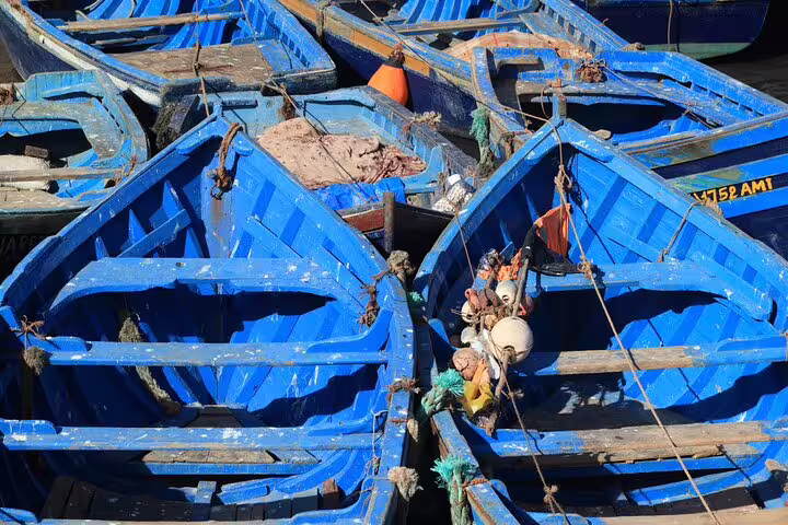 Blue fishing boats in Essaouira harbor, a highlight stop on a Morocco Essaouira walking tour along the port