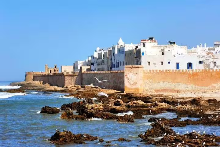 Atlantic waves below Essaouira medina walls and rocky shore, scenic view on Marrakech to Essaouira day trip