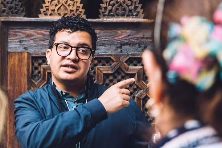 Local Essaouira guide explaining carved details during a Morocco Essaouira walking tour in the historic medina