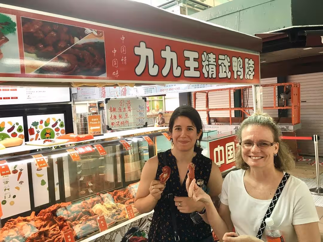 Visitors sampling Chinese cured meats on a cultural street food adventure.