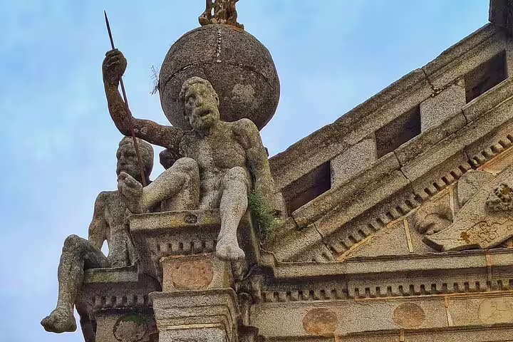 Close-up of intricate stone sculptures on a historic building in Évora, highlighting cultural heritage on a full-day tour from Lisbon.