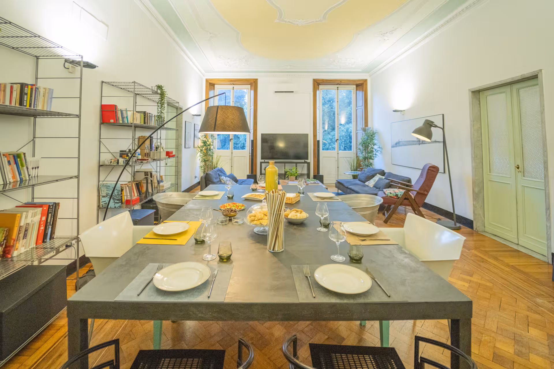 Elegant dining room set for exclusive private dinner with show cooking, featuring a long table and cozy decor.