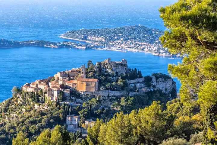 Aerial view of Eze Village with its medieval architecture perched on a hill overlooking the Mediterranean Sea.