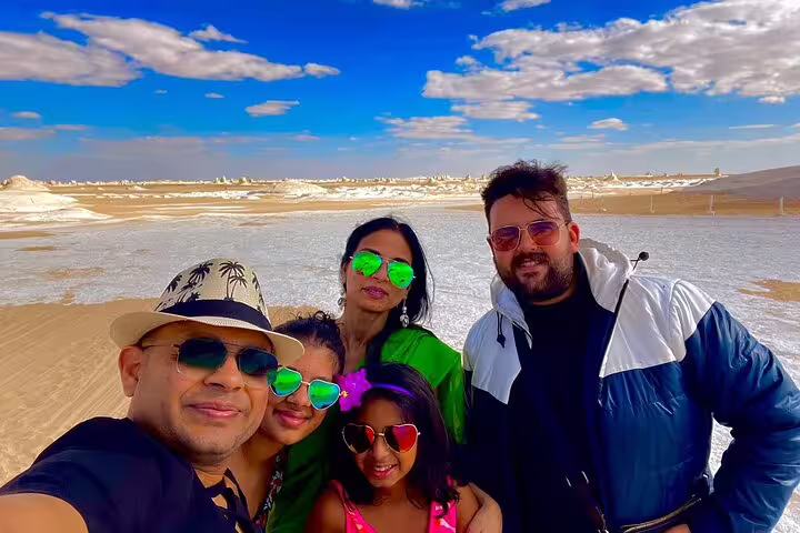Family selfie in Egypt’s White Desert on Bahariya Oasis overnight camping tour under bright blue skies