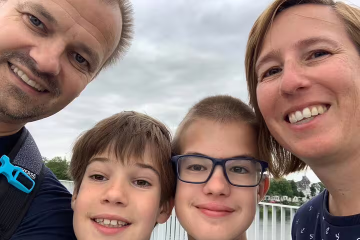 Family selfie on a riverside walk in Nancy while playing a self-paced e-scavenger hunt city discovery game