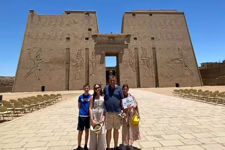 Family at Edfu Temple entrance on Aswan to Luxor overnight tour, visiting Kom Ombo and Edfu highlights