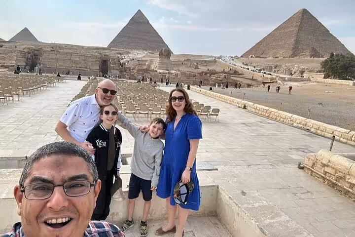 Family selfie at Giza Pyramids and Sphinx on private Sharm El Sheikh to Cairo domestic flight day tour