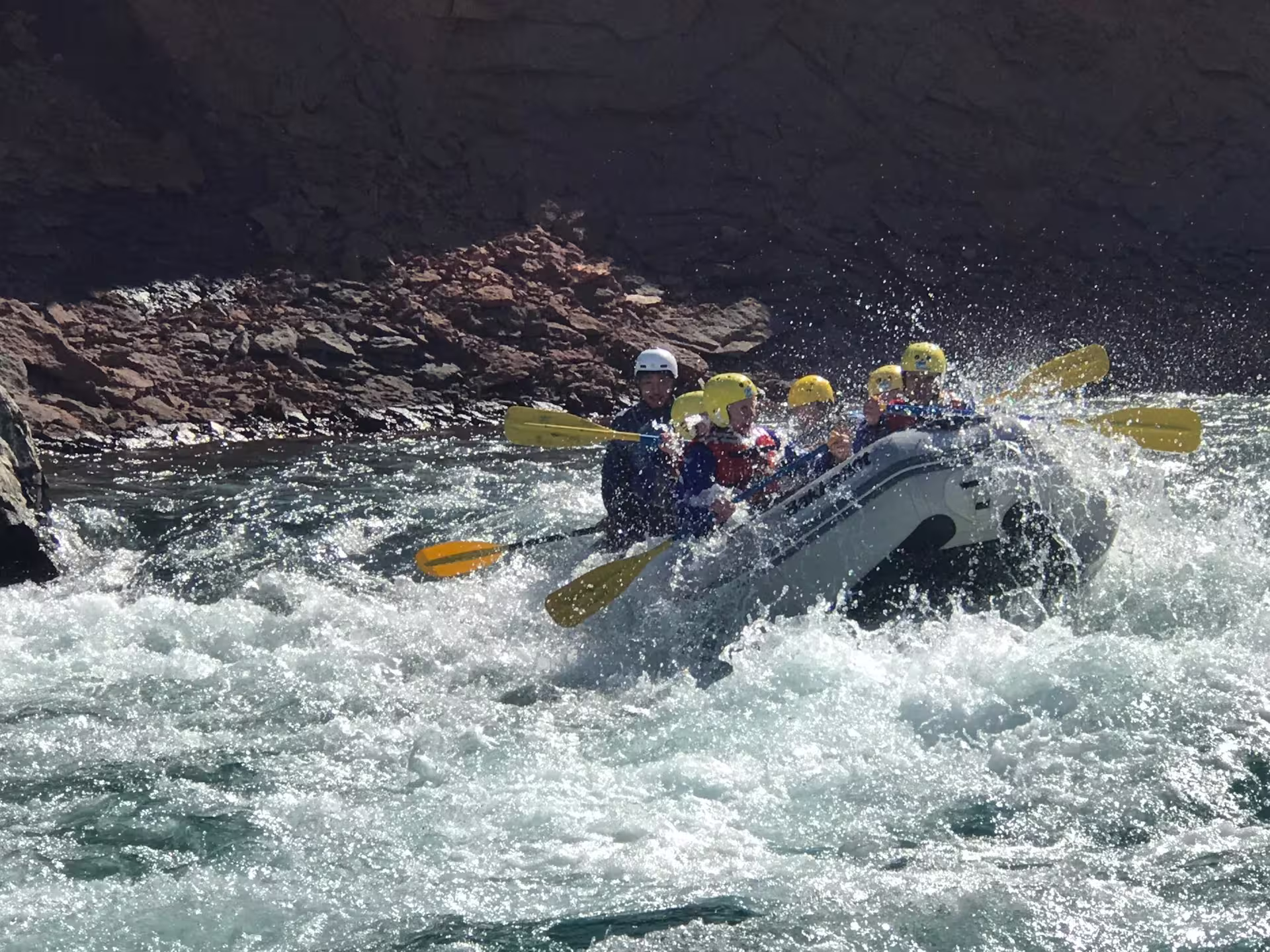 Family enjoying an exhilarating river rafting adventure, navigating through lively rapids with safety gear and vibrant paddles.