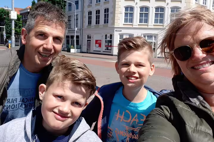 Family selfie during a self-paced e-scavenger hunt in Bergen (Mons), fun city discovery game for all ages